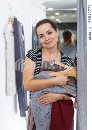 Woman trying clothes in fitting room Woman trying clothes in fitting room 48619776