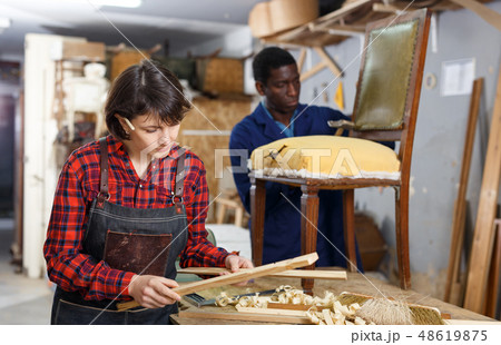 Artisans in process of renewing armchair Artisans in process of renewing armchair 48619875