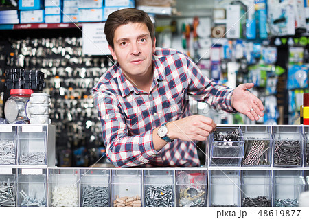 Employee selling nuts, screw and fasteners Employee selling nuts, screw and fasteners 48619877