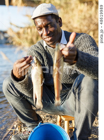 Man fishing with rods on river Man fishing with rods on river 48619989