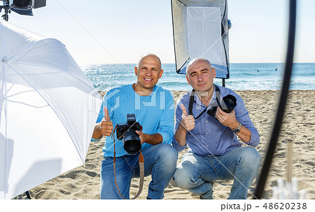 Portrait of two photographers on seaside 48620238