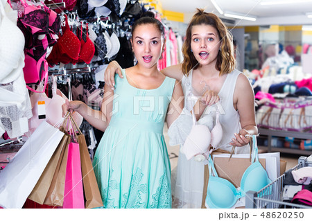 Cheerful girls are holding purchases Cheerful girls are holding purchases 48620250