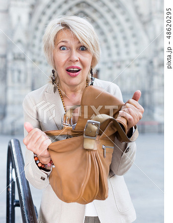 Mature female is displeased of theft from her bag 48620295