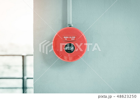 Red fire alarm button on wall. 48623250