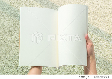 Hands holding blank open book or catalog mockup Hands holding blank open book or catalog mockup 48626553