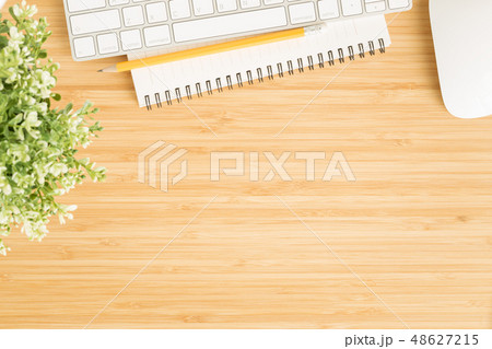 photo of office desk with mouse and keyboard 48627215