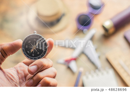 Man holding compass on blurred note 48628696