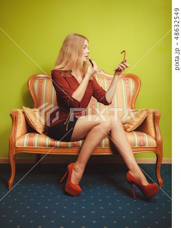 Attractive woman applying lipstick. Make up. Attractive woman applying lipstick. Make up. 48632549
