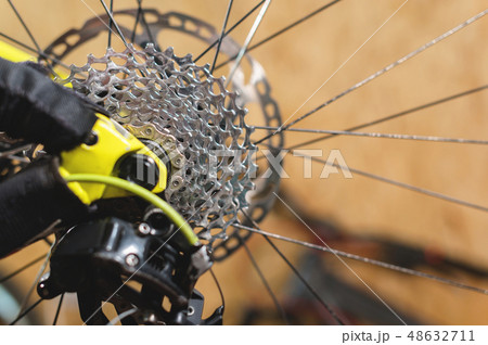 Close-up View of the bike in repair. Gear cassette close-up. Crafting service for mountain bikes Close-up View of the bike in repair. Gear cassette close-up. Crafting service for mountain bikes 48632711