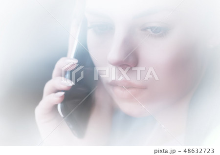 Closeup portrait attractive young girl talking on the phone. Non-contrast view through the Closeup portrait attractive young girl talking on the phone. Non-contrast view through the 48632723