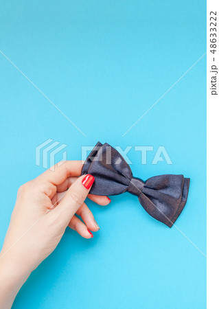 Black bow tie woman hand for men fathers concept 48633222