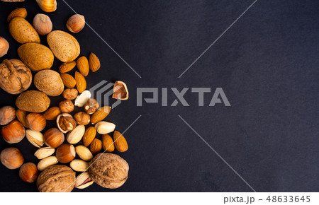 Various nuts on a pile top view 48633645