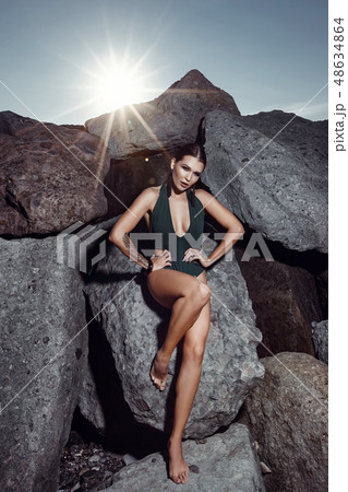 Beautiful girl in a swimsuit is posing at the 48634864