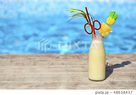 Glass of pinacolada cocktail standing on the 48638437