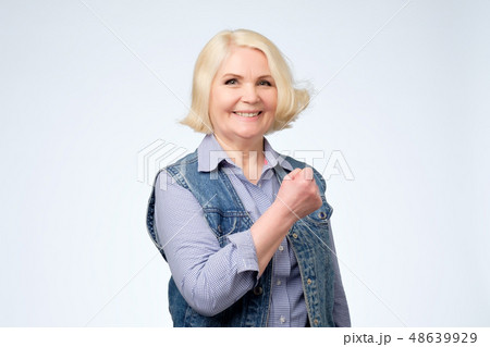 Beautiful lucky senior woman feeling excited Beautiful lucky senior woman feeling excited 48639929