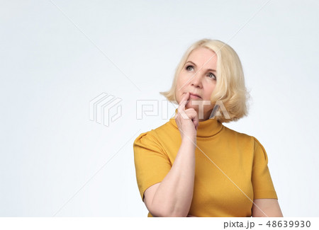 Senior woman looking confident up with smile Senior woman looking confident up with smile 48639930