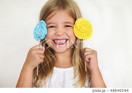 Cute little girl with candies Cute little girl with candies 48640594