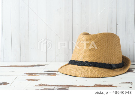 Straw hat on white boards with copy space. 48640948