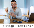 Bearded man having breakfast in the kitchen and 48641737