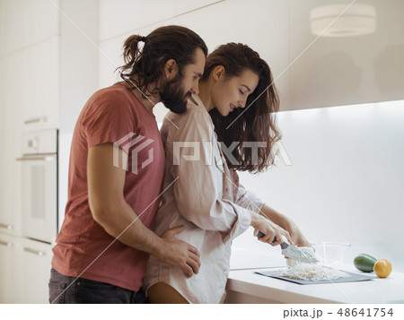 Smiling young couple cooking food in the kitchen 48641754