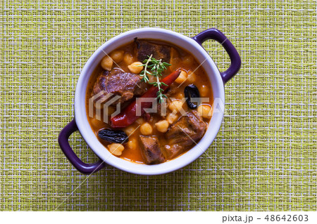 Stewed meat with bulgur and chickpeas in red sauce Stewed meat with bulgur and chickpeas in red sauce 48642603