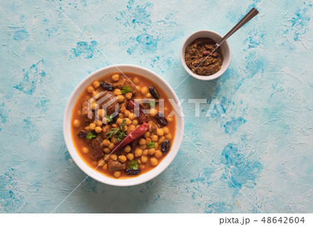 Stewed meat with bulgur and chickpeas in red sauce 48642604