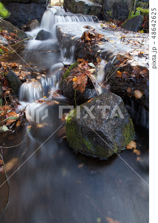 Water flowing over rocks in creek Water flowing over rocks in creek 48642625