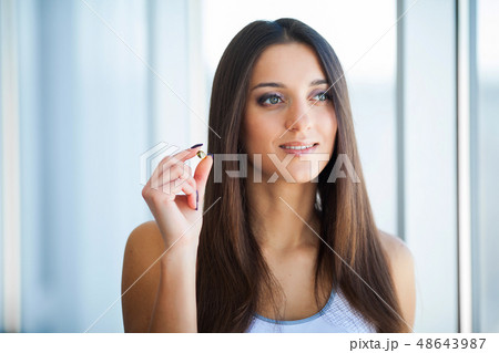 Beautiful Smiling Woman Taking Vitamin Pill. Dietary Supplement Beautiful Smiling Woman Taking Vitamin Pill. Dietary Supplement 48643987