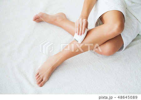 Skin care. Woman shaving her legs in bathroom Skin care. Woman shaving her legs in bathroom 48645089