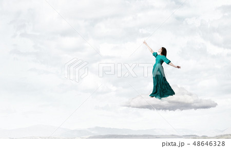 Woman in cloudy sky Woman in cloudy sky 48646328
