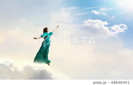 Woman in cloudy sky Woman in cloudy sky 48646401
