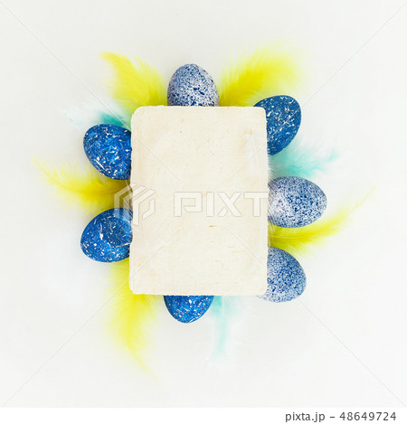 Blue Easter eggs with bright colorful feathers Blue Easter eggs with bright colorful feathers 48649724