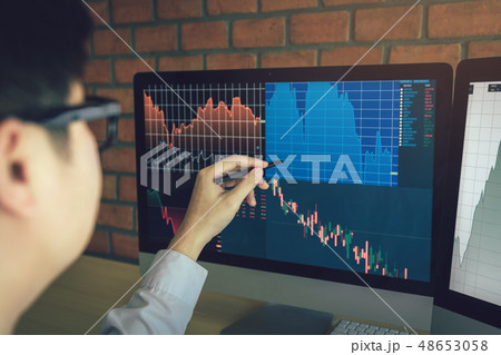 Young businessman working at stock market with 48653058