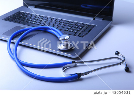 Workplace of doctor with laptop, stethoscope and RX prescription on white table. top view. Workplace of doctor with laptop, stethoscope and RX prescription on white table. top view. 48654631