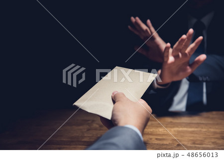Businessman rejecting money in the envelope, anti Businessman rejecting money in the envelope, anti 48656013