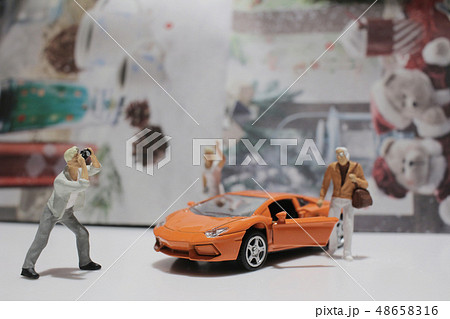 small figure with the toy sport car 48658316
