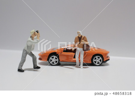 small figure with the toy sport car 48658318