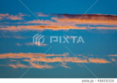 Orange clouds and bluish sky at dusk 48658320