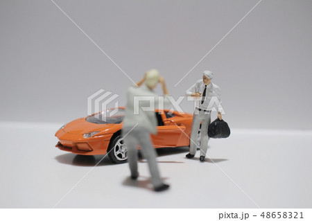 small figure with the toy sport car 48658321