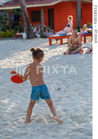Boy playing Frisbee on the beach Boy playing Frisbee on the beach 48658652