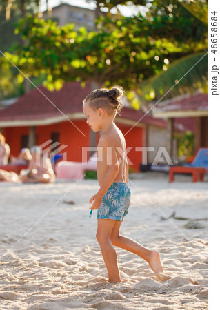 Boy playing Frisbee on the beach  48658684