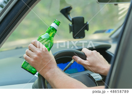 Man drinking beer in a car Man drinking beer in a car 48658789