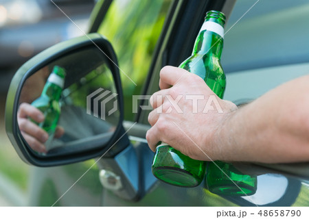 Man drinking beer in a car Man drinking beer in a car 48658790