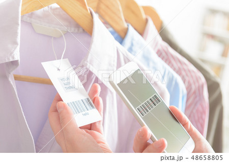 Woman scanning barcode with mobile phone 48658805