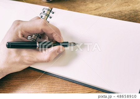 Close up of males hand writing 48658910