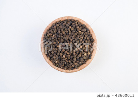 Black pepper peppercorns in wooden bowl isolated 48660013