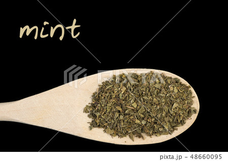 mint on wooden spoon isolated on black mint on wooden spoon isolated on black 48660095
