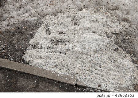 Deicing chemicals near asphalt road 48663352