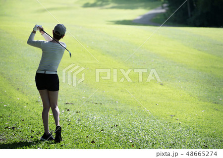 Asian woman playing golf on natural golf course 48665274