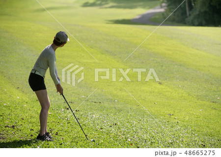 Asian woman playing golf on natural golf course 48665275